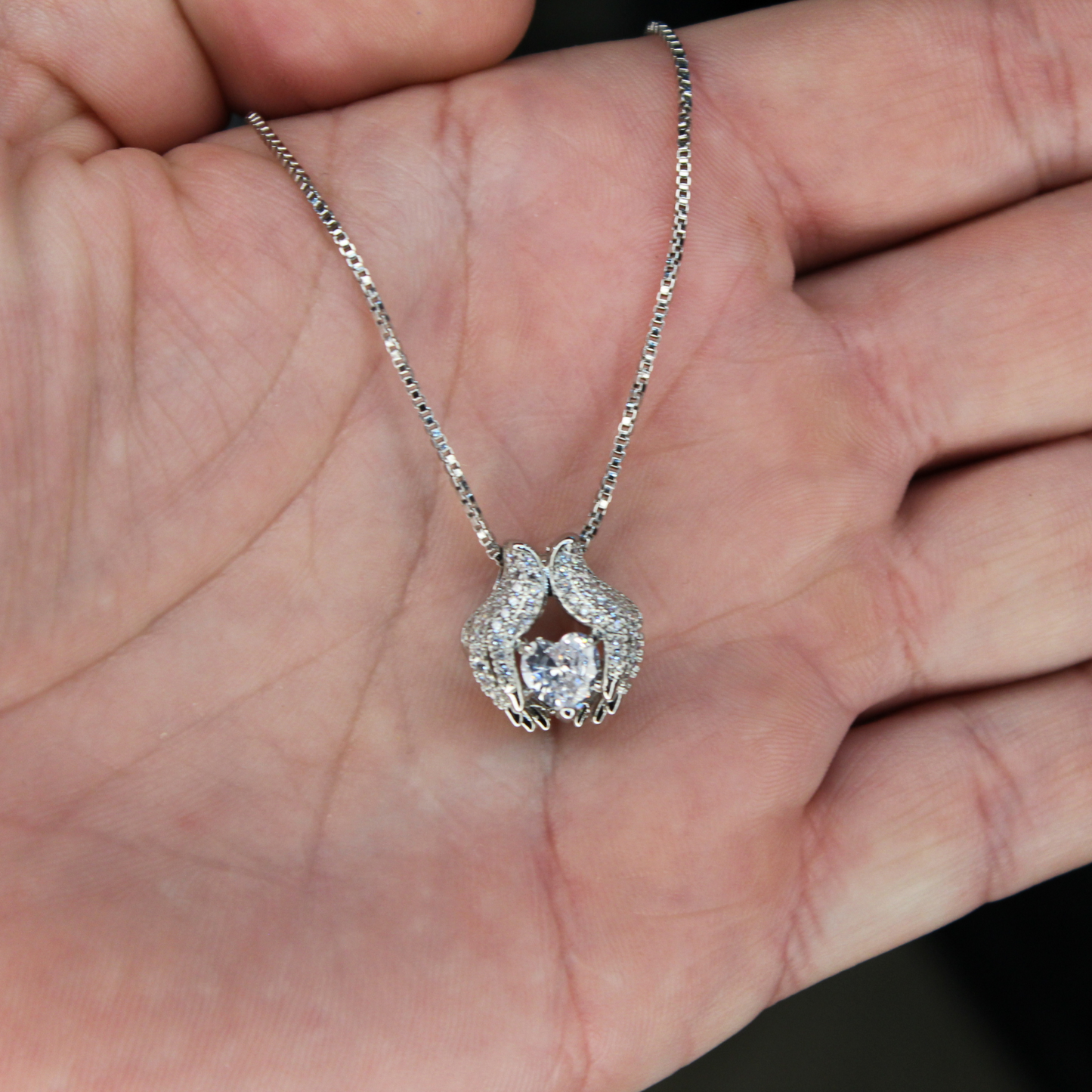 Hands Holding Love Necklace